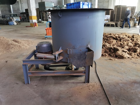 Sawdust glue mixing machine at work